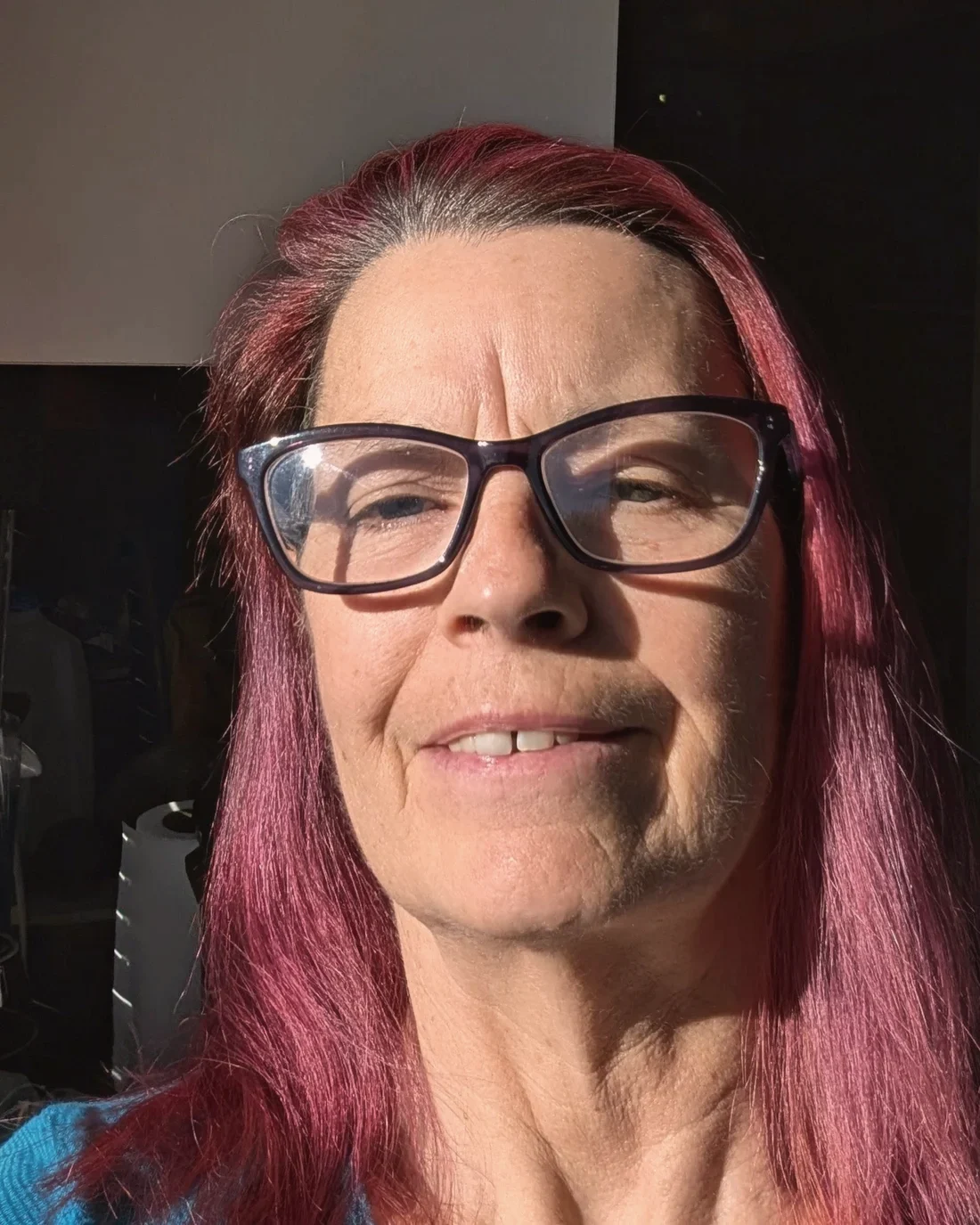 Kelly, founder of Kelly's Accurate Bookkeeping Service, photographed outdoors in warm daylight